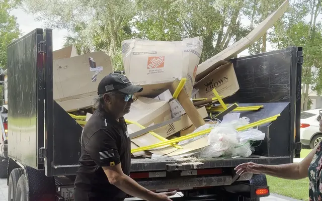Crew loading junk into an Eco Haul truck